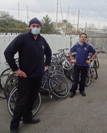 GTR's Dylan Lohman (left) delivers 25 abandoned bikes to Paul Horta-Hopkins at SCDA's recycling workshop