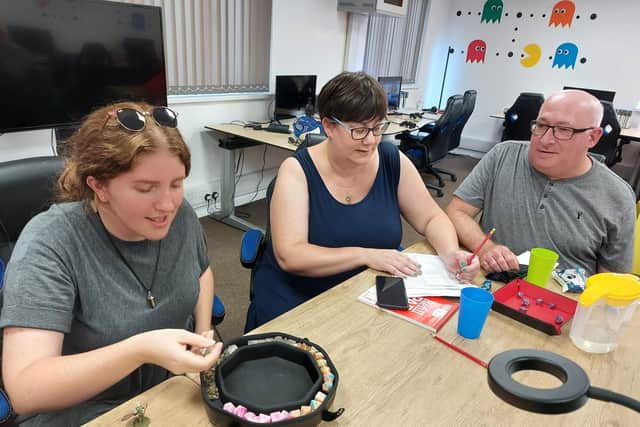 From left, Becky Hartt, Jo Barrett and Nick Barrett playing Dungeons and Dragons at Retro Gameplay in Cosham