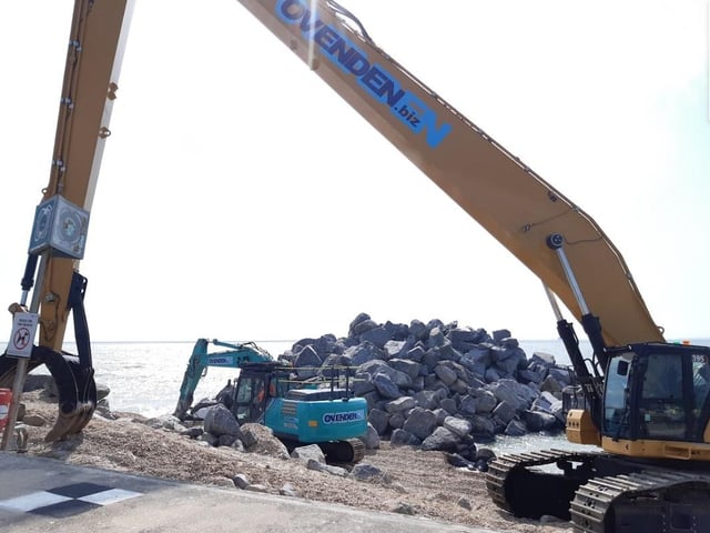 The green 'rock muncher' has arrived and is cutting larger rocks into smaller ones to help create tide pools