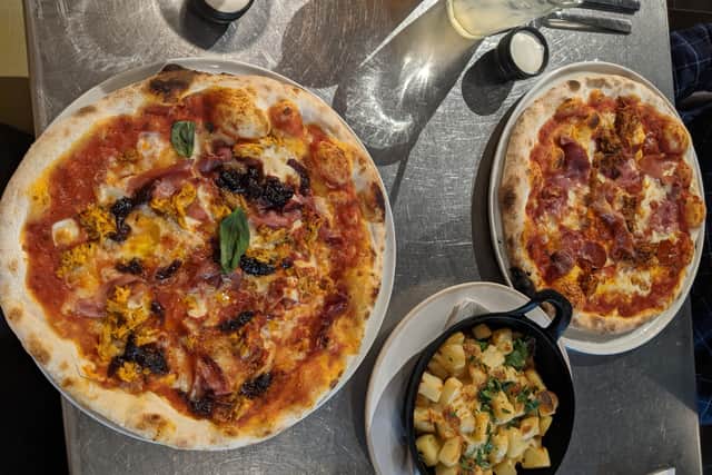 The Meat Up pizza, cheese potatoes and Classic Margarita with extra toppings.