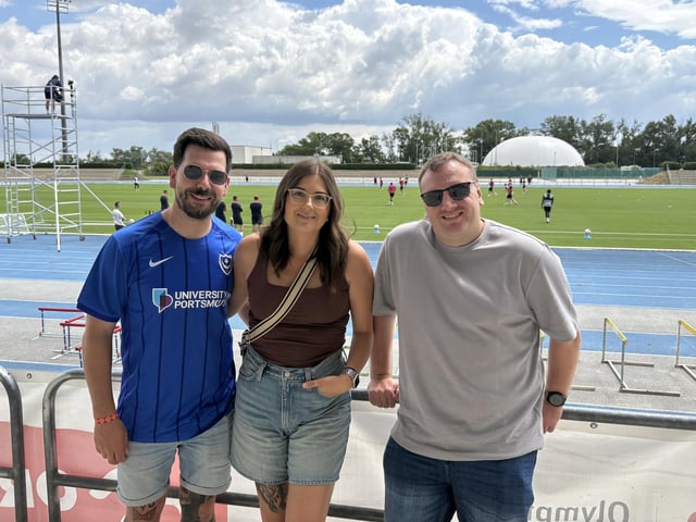 Ben Hardinge, aged 36 from Bristol, Mercedes Tilling, aged 34 from Bristol, and Arron Corless, aged 36 from Bromsgrove, at Pompey's open training session at the X-Bionic Sphere Sports Centre in Šamorín, Slovakia.