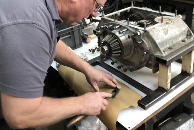 Senior Engineer Ian Stanfield makes a new gasket to seal the gearbox