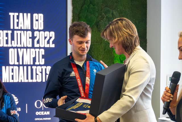 Dave Mouat is presented with his flag from Dame Katherine Grainger.