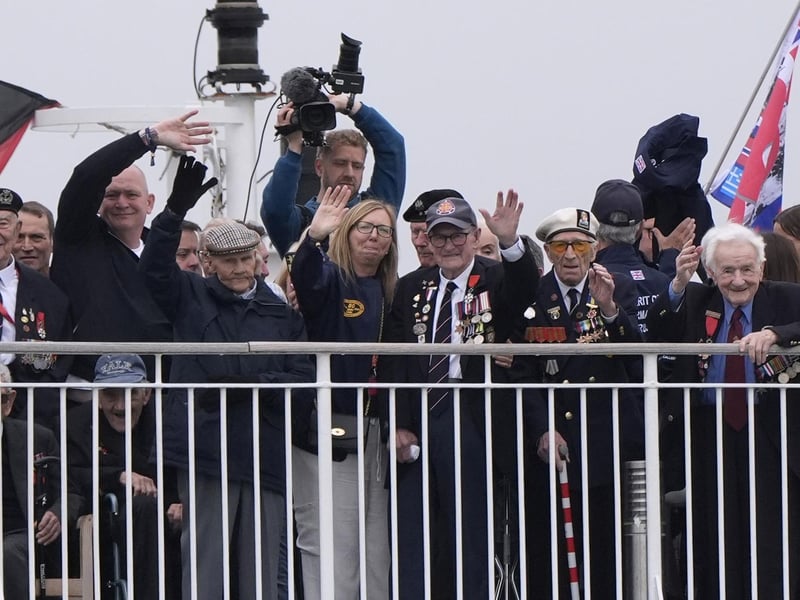 Normandy veterans wave from on board the Brittany Ferries ship Mont St Michel. Photo: Andrew Matthews/PA Wire