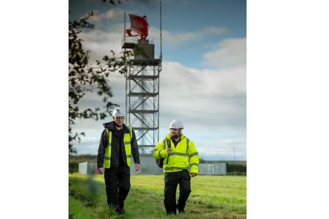 Maintainers pictured near one of the air traffic control radar installations they have been tasked to keep up and running.