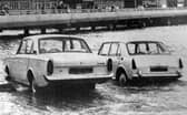 Two cars about to be overcome by the tide on the slipway at the  Hard in 1970. The new approach road from the Hard to the Harbour Station can be seen in the background.
