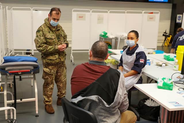 Naval Regional Commander Brigadire Jock Fraser, Royal Marines, supporting a team of Navy medics to deliver Covid-19 jabs.