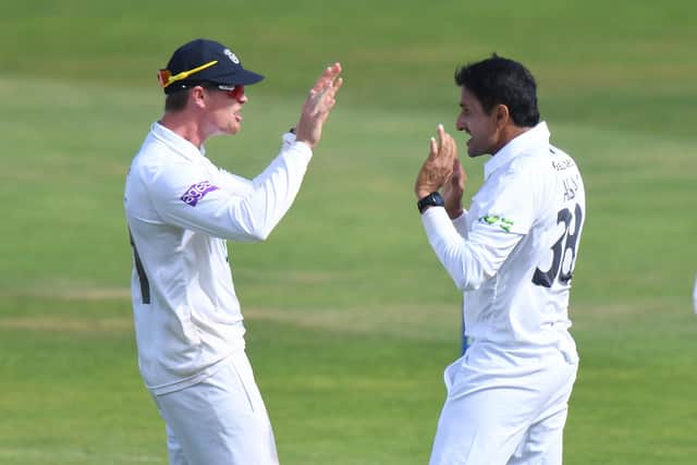 Mohammad Abbas and Nick Gubbins celebrate the wicket of Sam Hain. Photo by Tony Marshall/Getty Images.