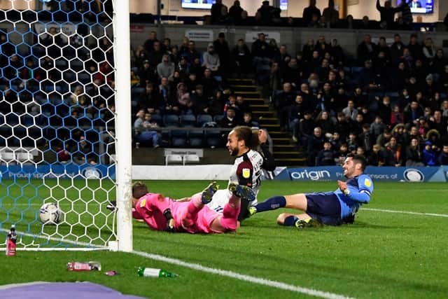 Marcus Harness bundles how George Hirst's cross to earn Pompey victory at Wycombe. Picture: Graham Hunt/ProSportsImages