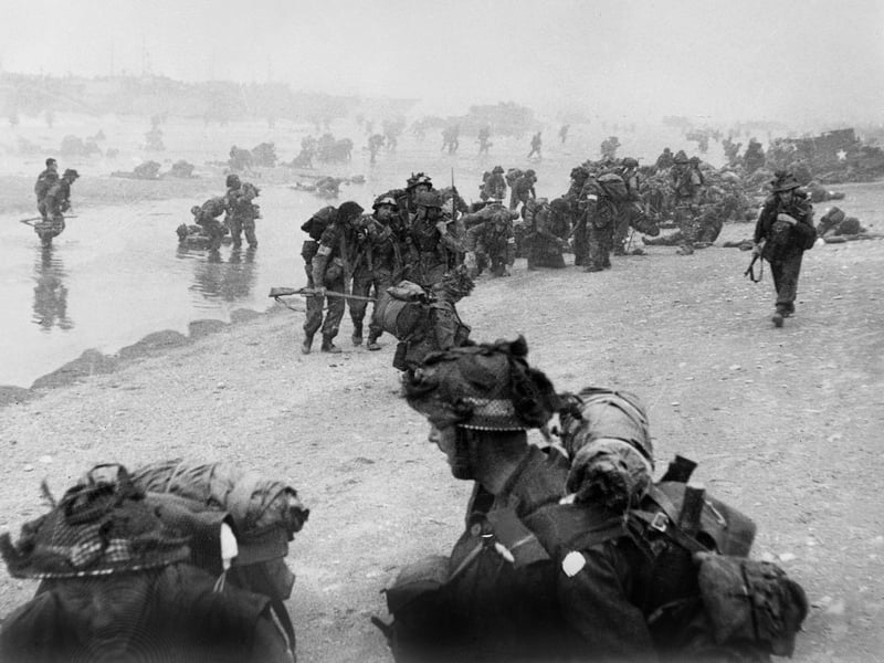 British troops take positions on Sword beach during D-Day June 6 1944 after Allied forces stormed the Normandy beaches. D-Day, 06 June 1944 is still one of the world's most gut-wrenching and consequential battles, as the Allied landing in Normandy led to the liberation of France which marked the turning point in the Western theater of World War II. (Photo credit should read STR/AFP/Getty Images)