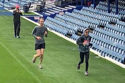 Libby Higgins, 19 from Waterlooville, took on the virtual London Marathon in honour of her friend who has leukaemia. Pictured: Libby completing the final 5km around Fratton Park with her friend Peter Dawes