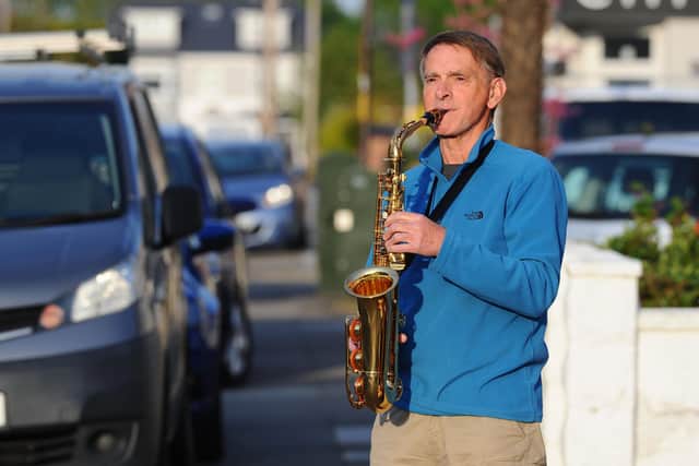 Neighbour, Andrew Rudd, 67, led the birthday song on his saxophone.
Picture: Sarah Standing