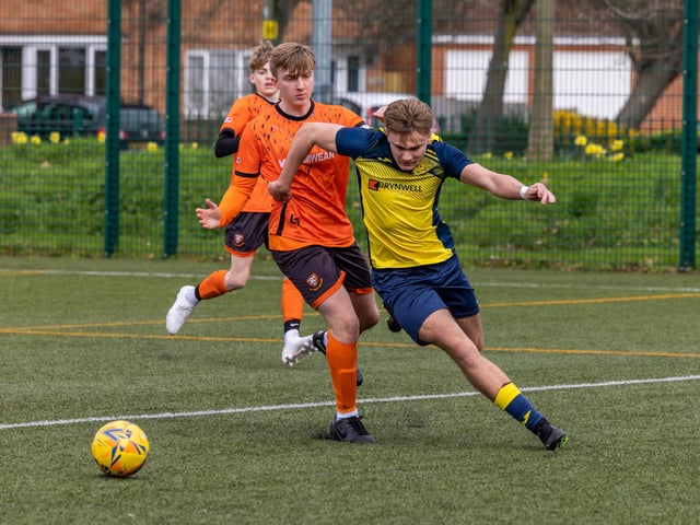 Action from the 2-2 draw between the under-18s of Moneyfields (blue/yellow kit) and AFC Portchester (orange/black kit). Picture: Mike Cooter