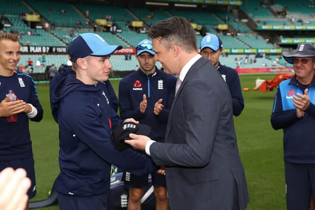 Mason Crane receives his test cap from former England cricketer Graeme Swann during day one of the Fifth Test match in the 2017/18 Ashes Series at Sydney in January 2018. Photo by Ryan Pierse/Getty Images.