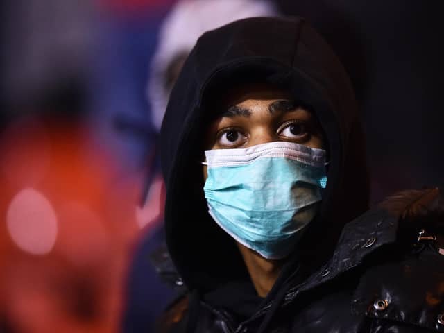 NOTTINGHAM, ENGLAND - MARCH 06: A fan wears a face mask as protection from Coronavirus during the Sky Bet Championship match between Nottingham Forest and Millwall at City Ground on March 06, 2020 in Nottingham, England. (Photo by Nathan Stirk/Getty Images)