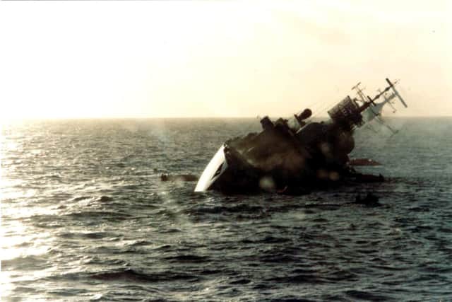 The British destroyer HMS Coventry sinks after being hit by bombs from Argentine Skyhawk aircraft on May 25, 1982