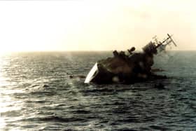 The British destroyer HMS Coventry sinks after being hit by bombs from Argentine Skyhawk aircraft on May 25, 1982