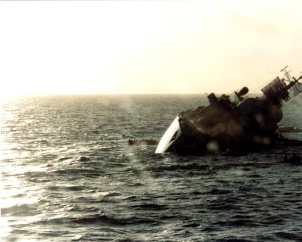 The British destroyer HMS Coventry sinks after being hit by bombs from Argentine Skyhawk aircraft on May 25, 1982
