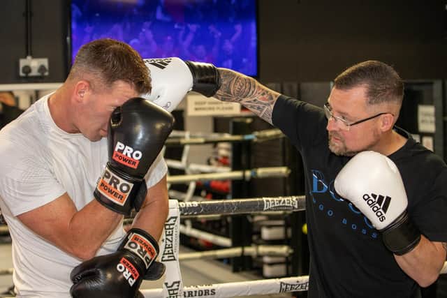 Gym owner Brian Davidson sparring with Gary Monger in the ring.