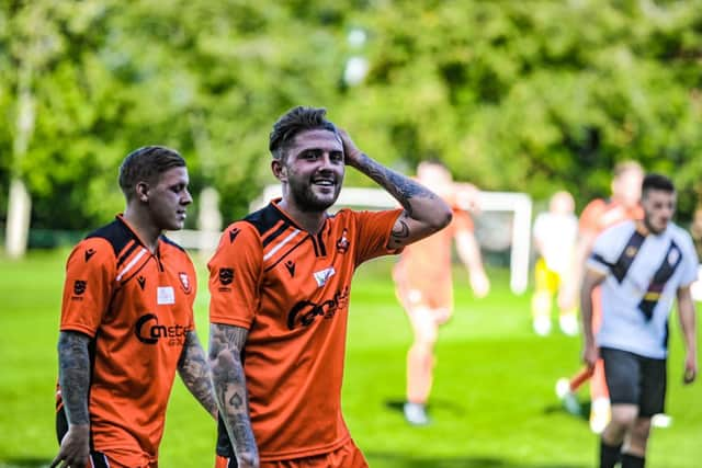 James Cowan, right, walks off after his two-goal performance at Alresford. Picture by Daniel Haswell.