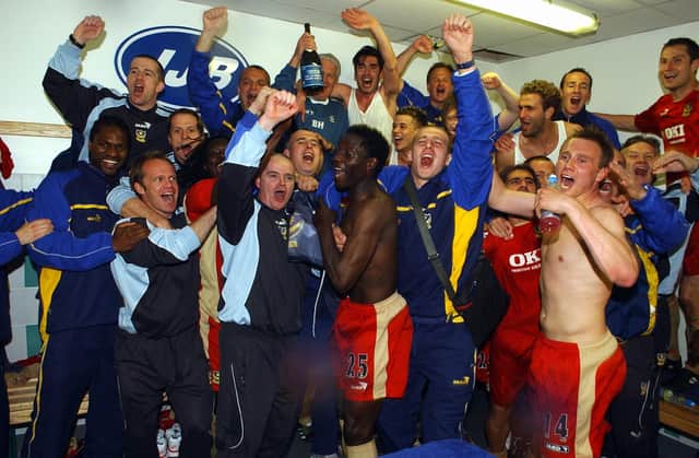 Pompey celebrate in the Wigan dressing room after staying up in April 2006. Brian Priske is pictured far right at the back. Picture: Steve Reid