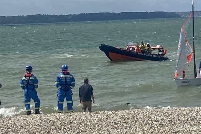 Coastguard rescue teams plucked two people from the water after their sailing dinghy capsized.