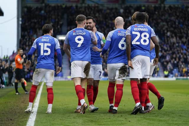 The Pompey players celebrate Colby Bishop's 49th-minute opener.