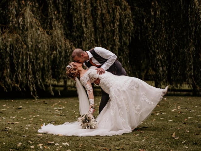 The Tithe Barn, located on Old Ditcham Farm, is an outstanding wedding venue with plenty of photo opportunities throughout.
The venue's website says: 'The Tithe Barn can be the backdrop to the wedding of your dreams.'
Pictured: Amy and Craig Hughes after tying the knot at The Tithe Barn, Petersfield.