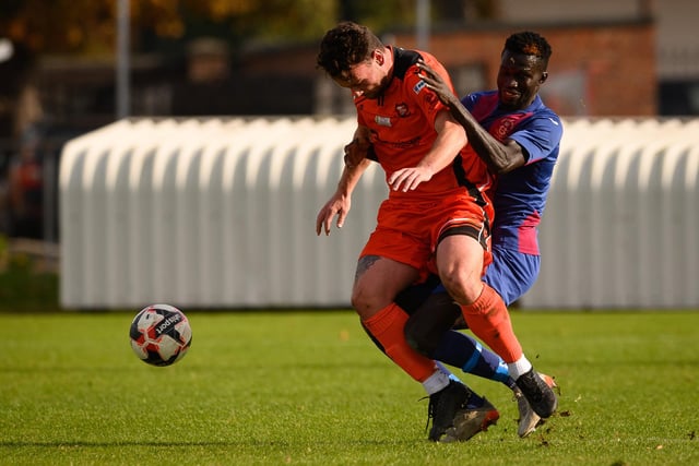 Portchester's Charlie Williamson and  USP striker Lamin Jatta. Picture: Keith Woodland