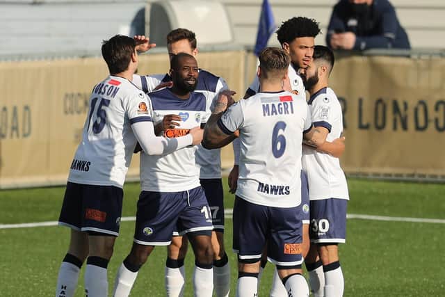 Bedsente Gomis (second left) celebrates after heading Hawks into a 2-1 lead. Photo by Dave Haines
