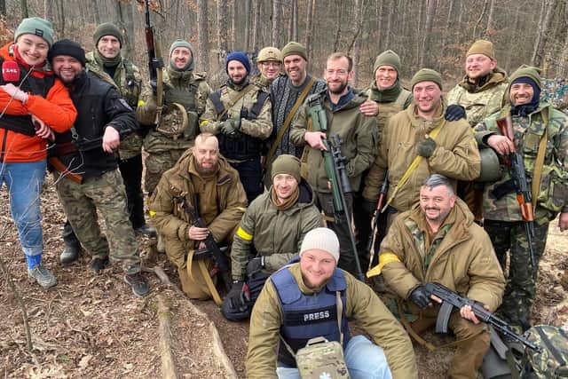 Shane, pictured in the centre holding the sniper rifle, says he has helped to train more than 500 Ukrainian fighters since arriving in the country.