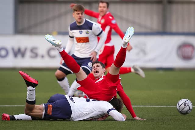 A Hungerford player goes over the top of Christian Rowe. Picture: Chris Moorhouse