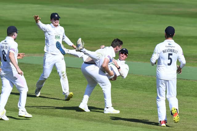 Brad Wheal celebrates with Nick Gubbins after taking the wicket of Chemar Holder as Hampshire defeat Warwickshire by 60 runs at Edgbaston. Photo by Tony Marshall/Getty Images.