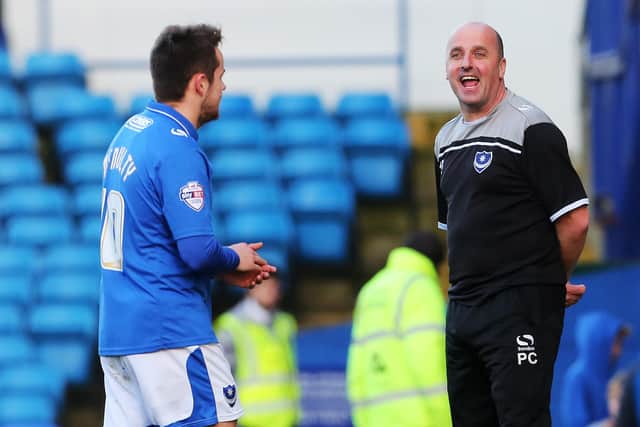 Paul Cook has a joke with Marc McNulty during his time at Pompey. Picture: Joe Peple
