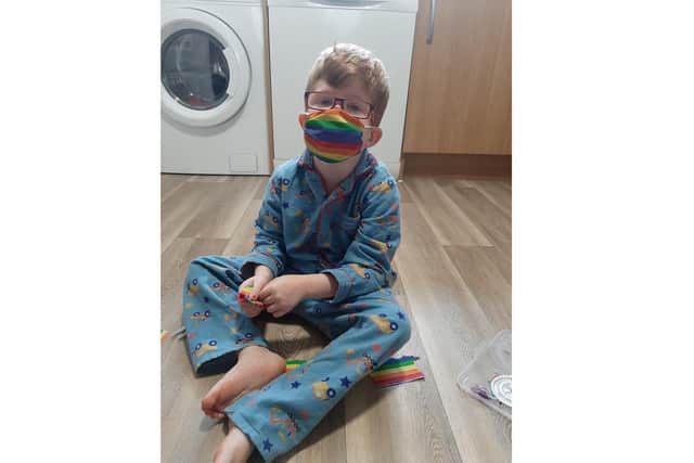 Ezra Meredith, four from Waterlooville, has been creating rainbow face masks with his mum Lucy Clilverd, to raise money for the NHS which has supported him with his cerebral palsy. Pictured here with a mask he has made