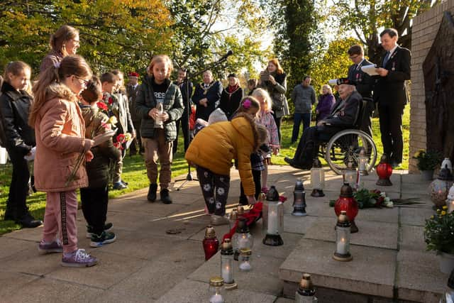 School children also laid wreaths and candles. Picture: Keith Woodland (071121-120)