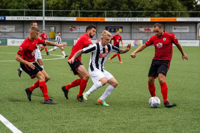 Hayling striker Max Davies is surrounded by Locks players. Photo by Matthew Clark