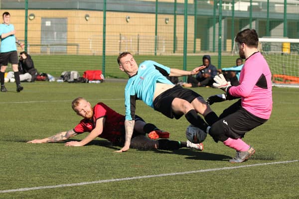 Burrfields striker Jack Palmer challenges the Horndean keeper. Picture by Kevin Shipp