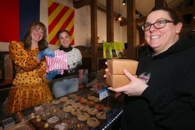 Annie Walker buys cakes from Emma Shepperd, left, and Luisa Ricci on Ms Shepperd's Oh Yum Yum Yum cake stall. Powder Monkey Brewery Christmas Market, Priddy's Hard, Gosport.
Picture: Chris Moorhouse