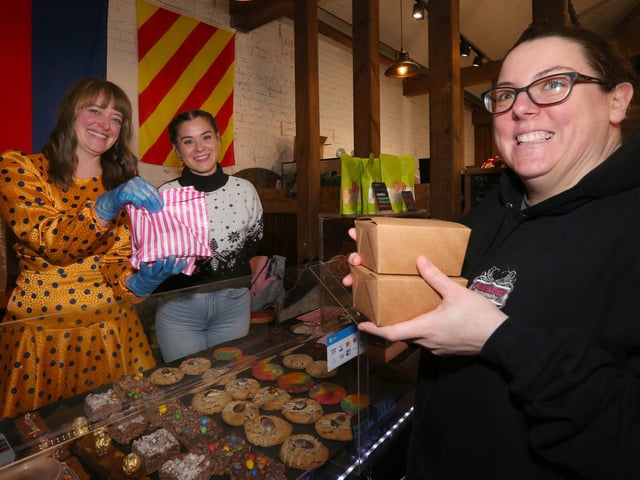 Annie Walker buys cakes from Emma Shepperd, left, and Luisa Ricci on Ms Shepperd's Oh Yum Yum Yum cake stall. Powder Monkey Brewery Christmas Market, Priddy's Hard, Gosport.
Picture: Chris Moorhouse