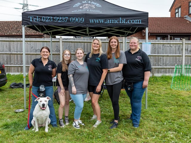 The team at The Academy of Modern Canine Behaviour and Training (AMCBT). Pictured: Michelle Hopkins (40), Amy Shrimpton (12), April Stafford (25), Aimee Styles (32), Poppie Bulloch (20), Carlyanne Saffery (36) with Luna (Staffordshire bull terrier cross American bulldog). Picture: Mike Cooter (210724)