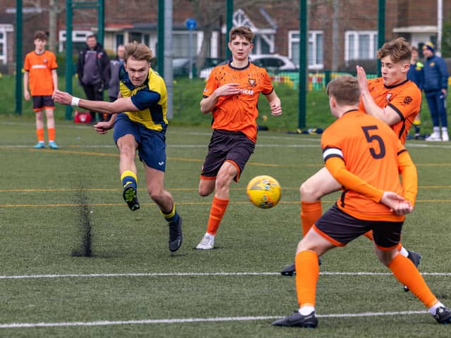 Action from the 2-2 draw between the under-18s of Moneyfields (blue/yellow kit) and AFC Portchester (orange/black kit). Picture: Mike Cooter