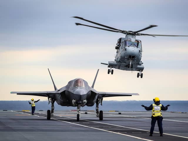An F-35 jet and a Merlin helicopter on the deck of HMS Queen Elizabeth