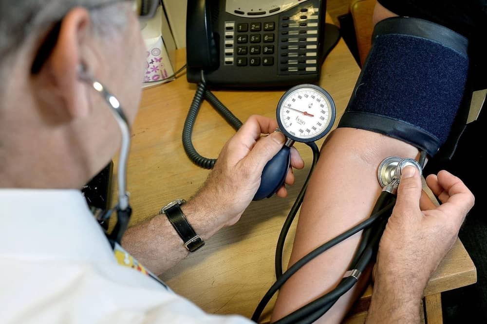 A GP takes a patient's blood pressure