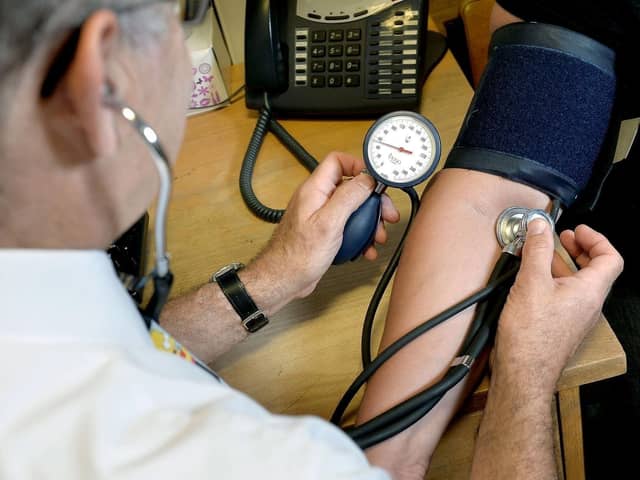 A GP takes a patient's blood pressure