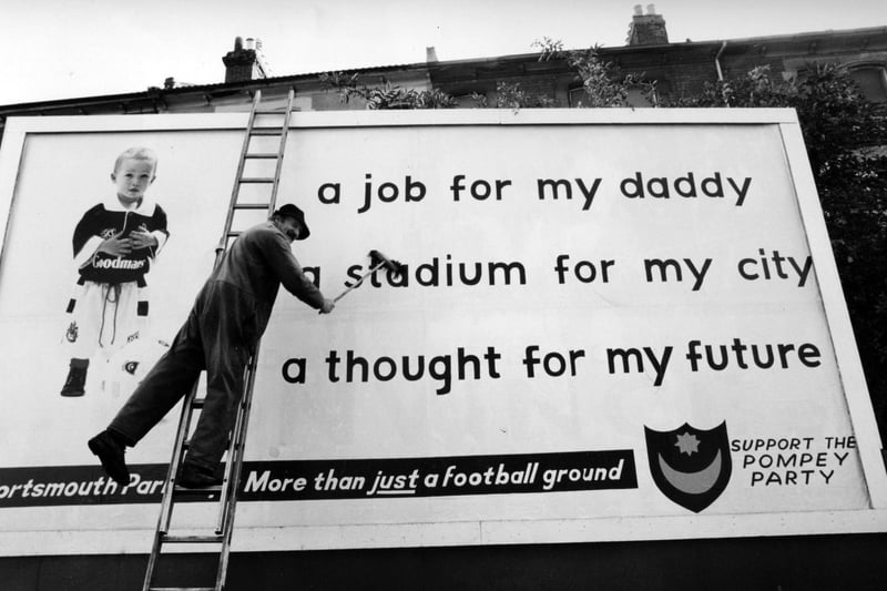 Brian Crawford puts up Pompey Party poster on a hoarding in Kingston Crescent, Portsmouth, 1993. The News PP5058