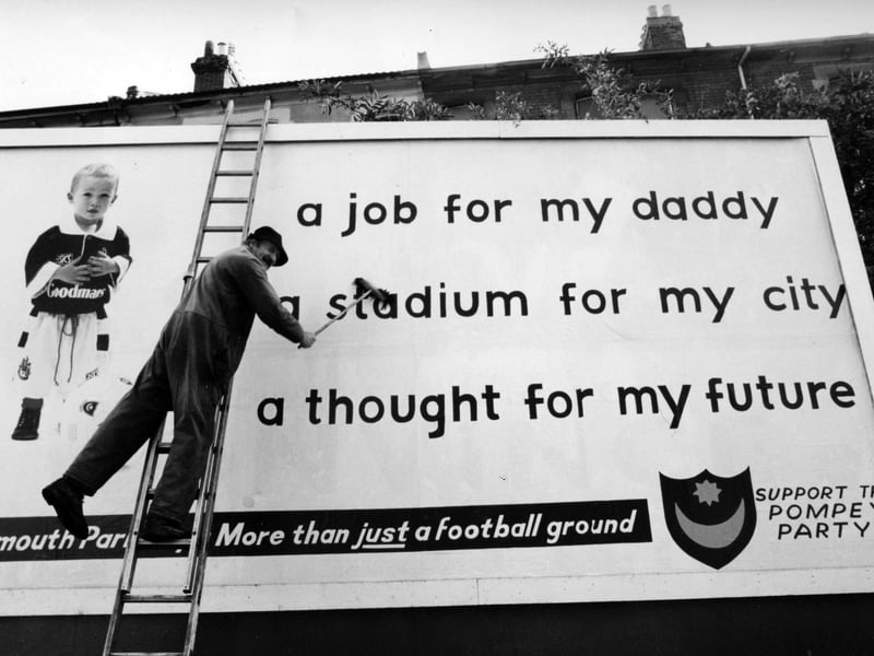 Brian Crawford puts up Pompey Party poster on a hoarding in Kingston Crescent, Portsmouth, 1993. The News PP5058