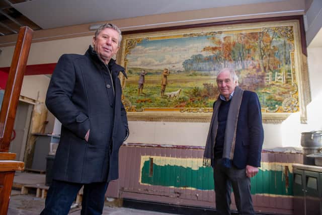 Owners of the pub, Mick Forfar and Steve Kingsley in front of a historic tile artwork uncovered during the venue's refurbishment. Picture: Habibur Rahman