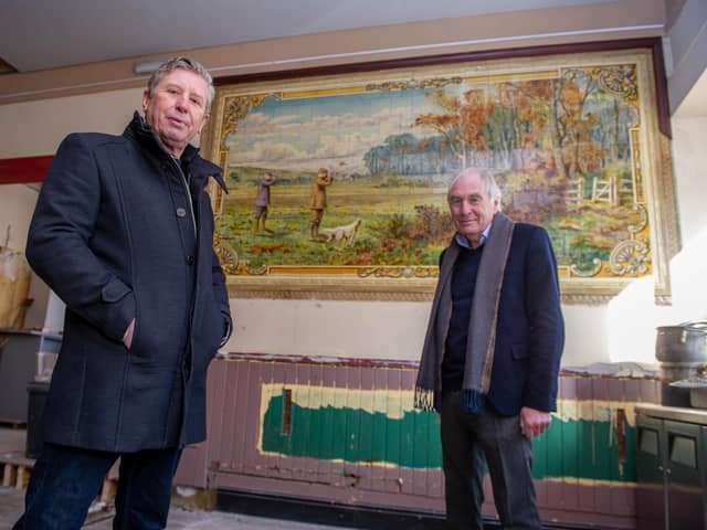 Owners of the pub, Mick Forfar and Steve Kingsley in front of a historic tile artwork uncovered during the venue's refurbishment. Picture: Habibur Rahman