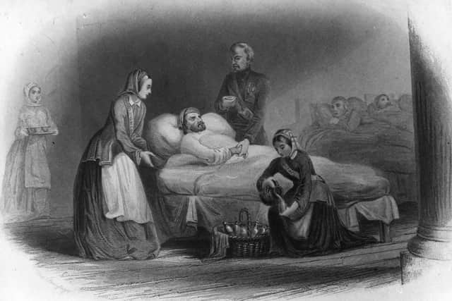 circa 1856:  British nurse and hospital reformer Florence Nightingale (1820 - 1910), standing left, nursing wounded soldiers during the Crimean War.  (Photo by Edward Gooch Collection/Getty Images)